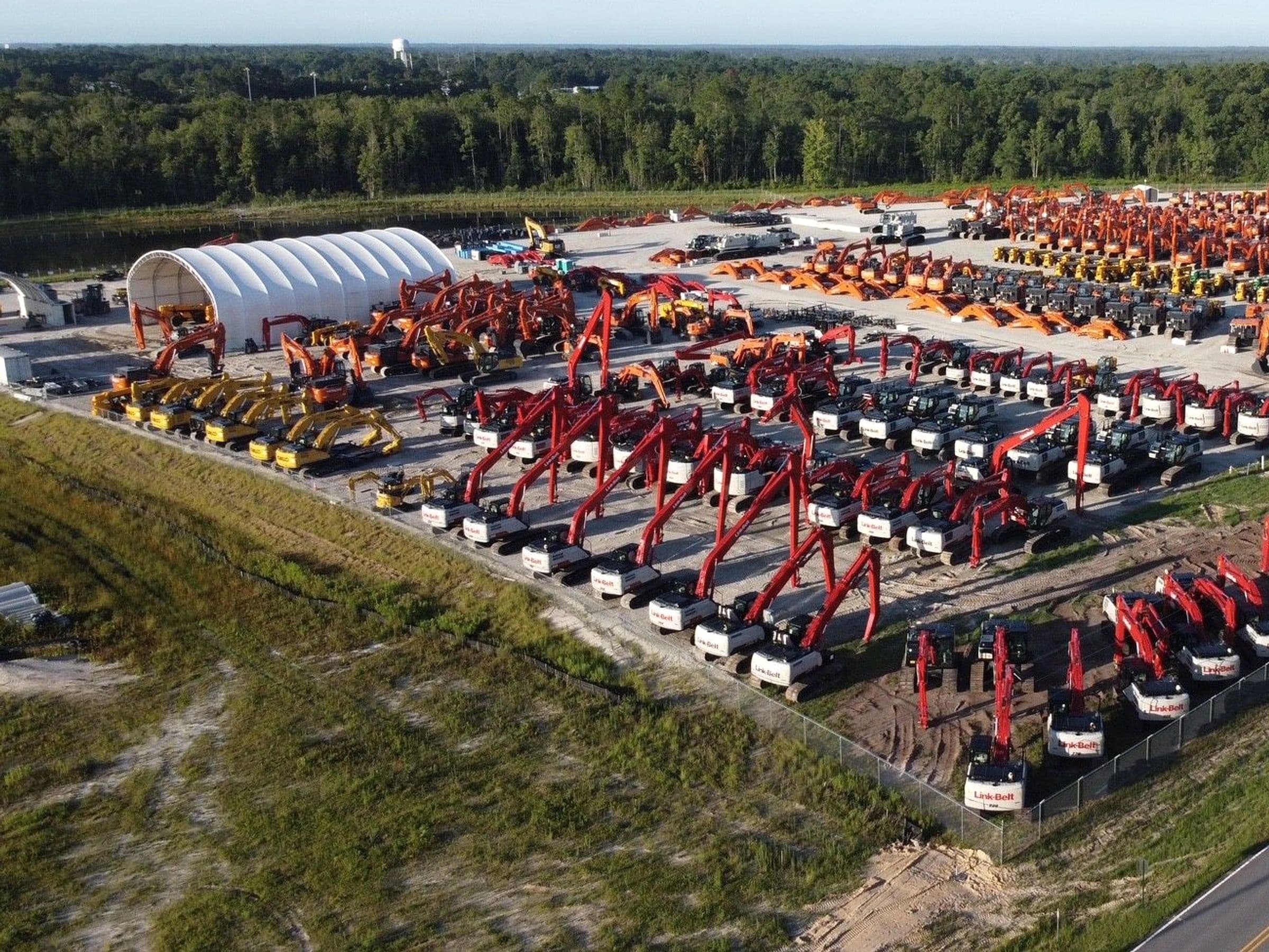 Aerial view of rows of construction equipment at a JBH Equipment Processing Center