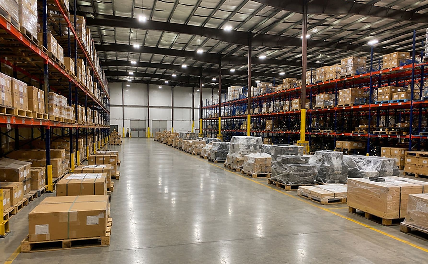 JBH parts distribution warehouse interior — pallet racking with staged OEM shipments